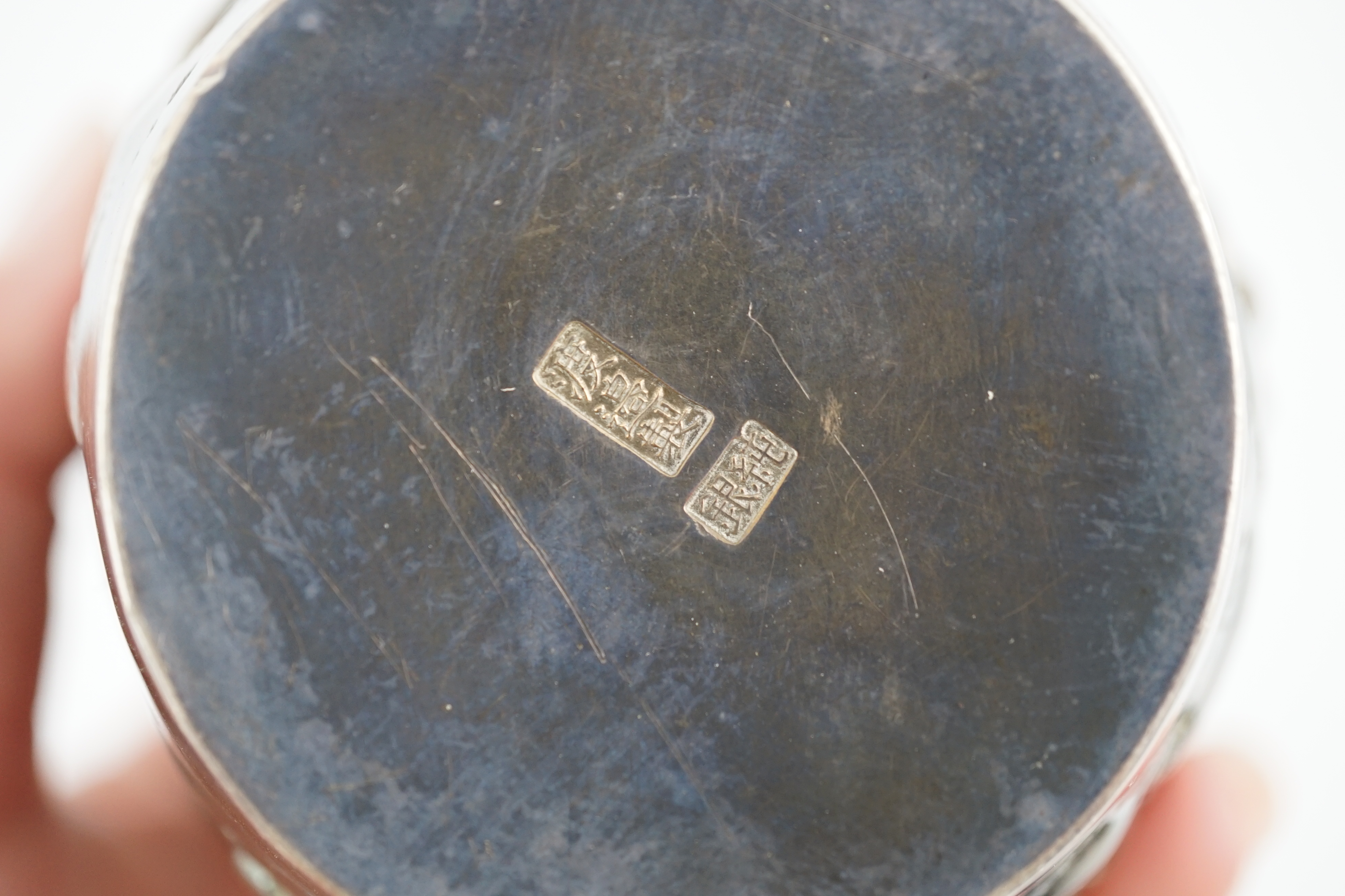 An early 20th century Japanese silver ovoid tea caddy and cover, decorated with prunus, together with a similar Japanese silver bowl